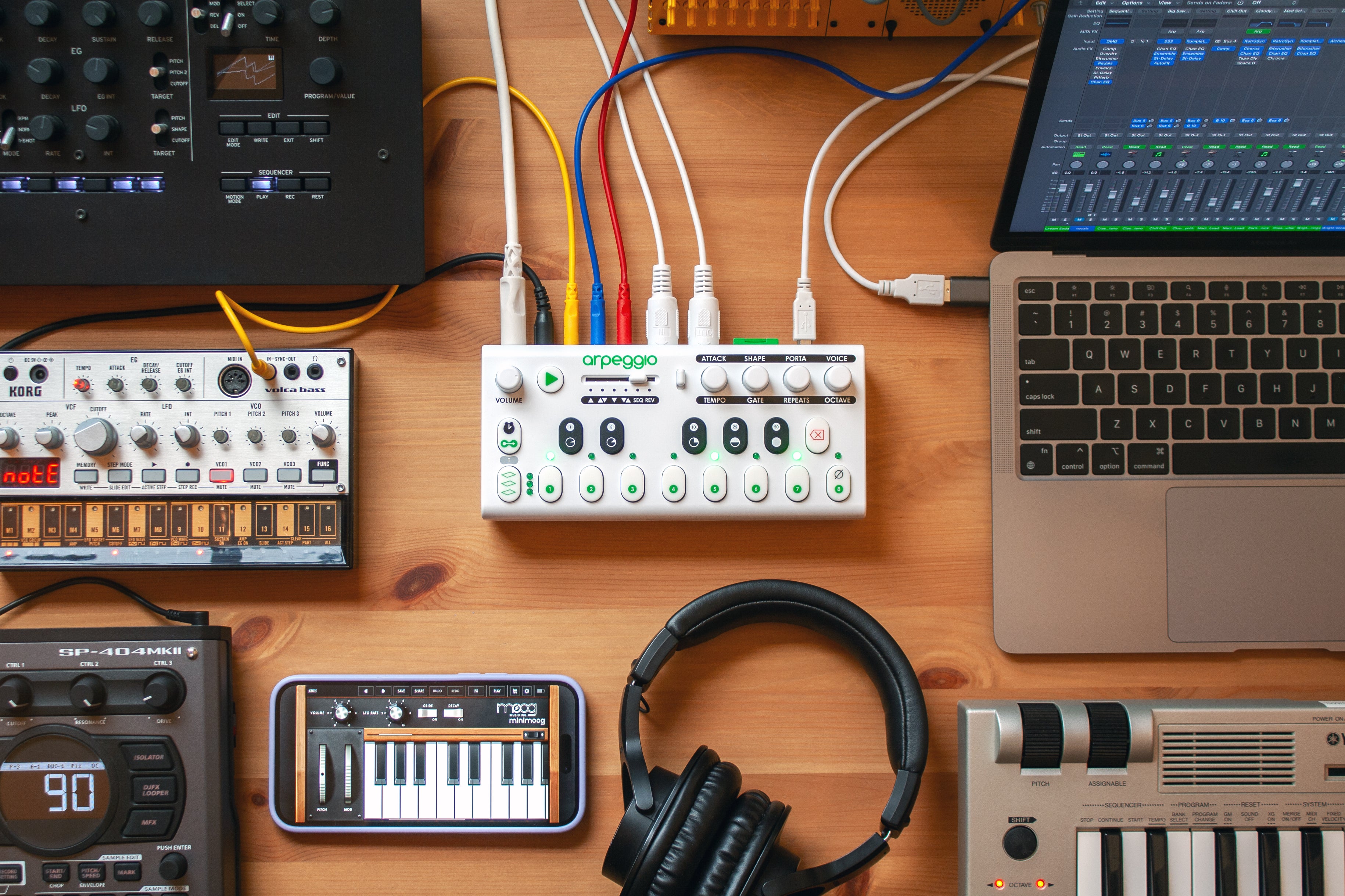 Arpeggio on a table surrounded and connected to other electronic musical instruments.